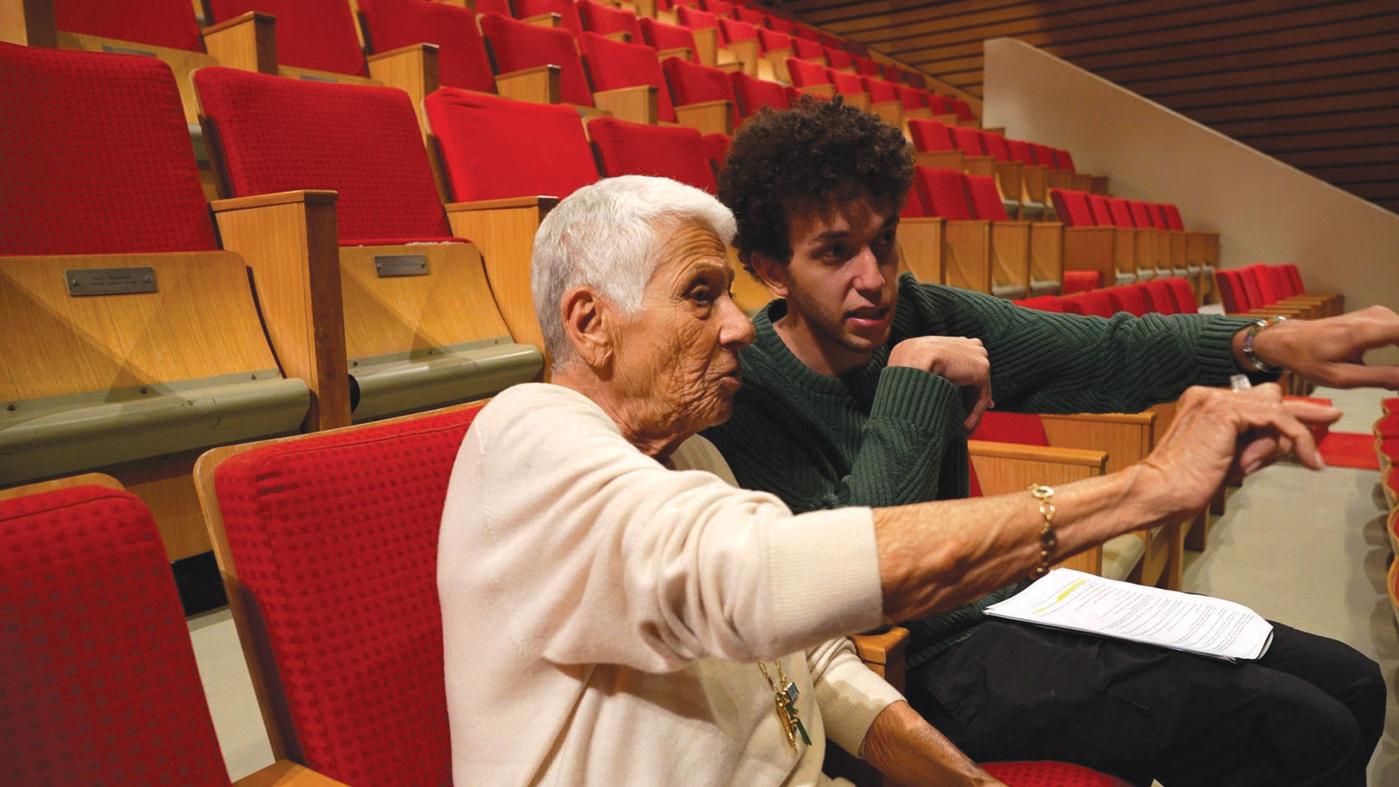 Saad working with students in a theater