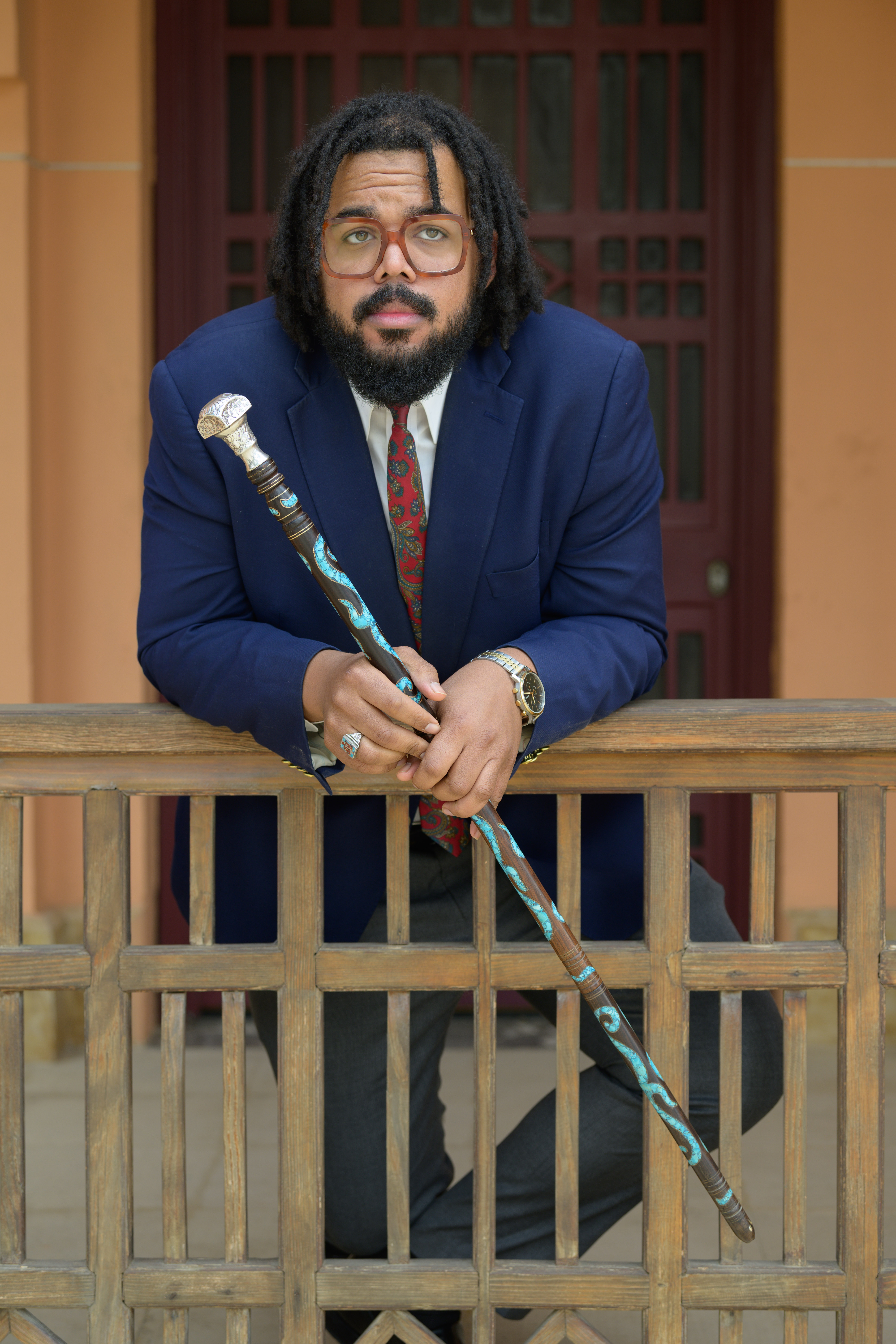 Seneca Forch leans on a porch with a cane