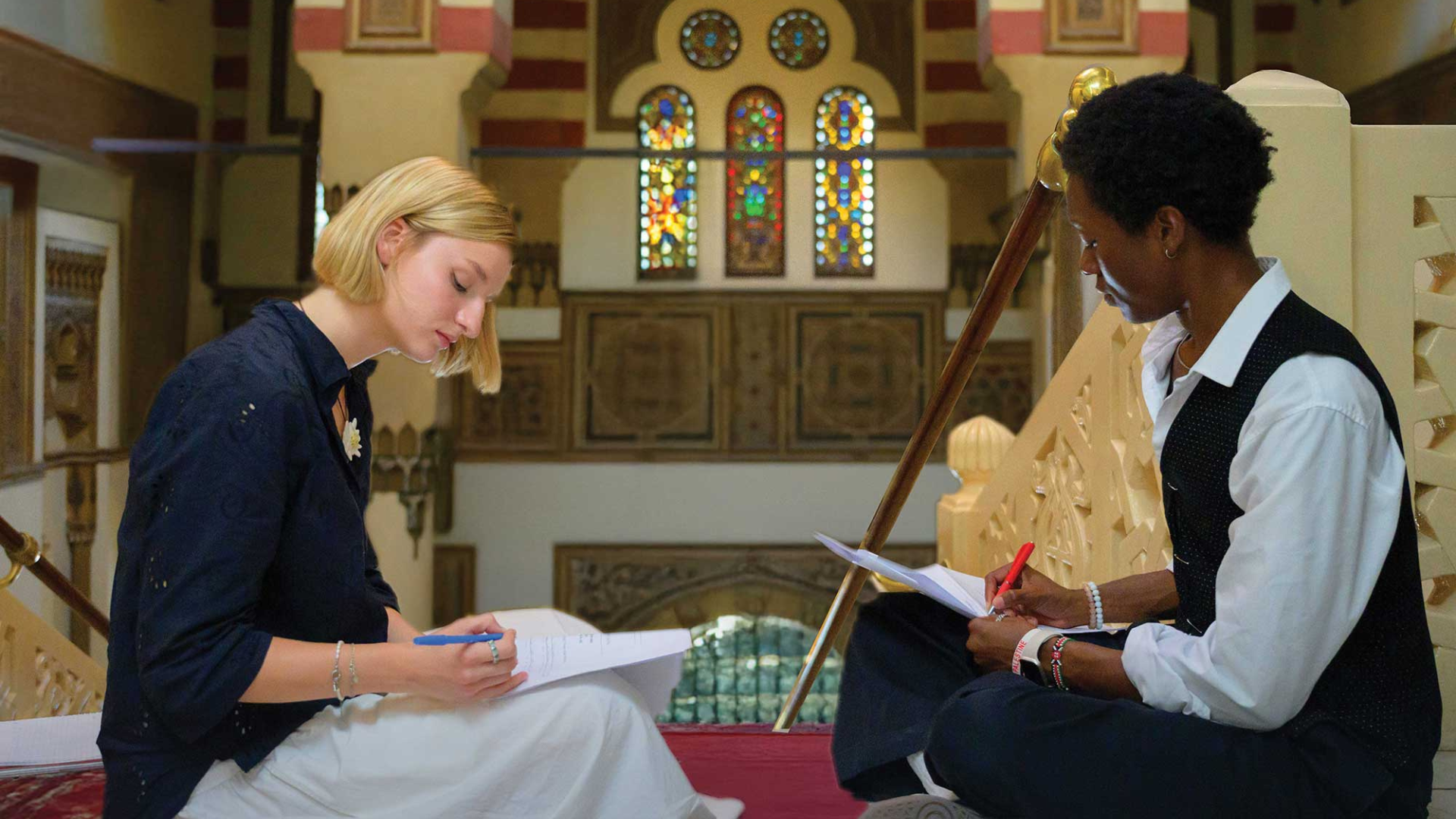 Creative Writing students sitting on the Presidential Stairs, taking inspiration from the surrounding architecture and vibrancy of the Tahrir Square campus.