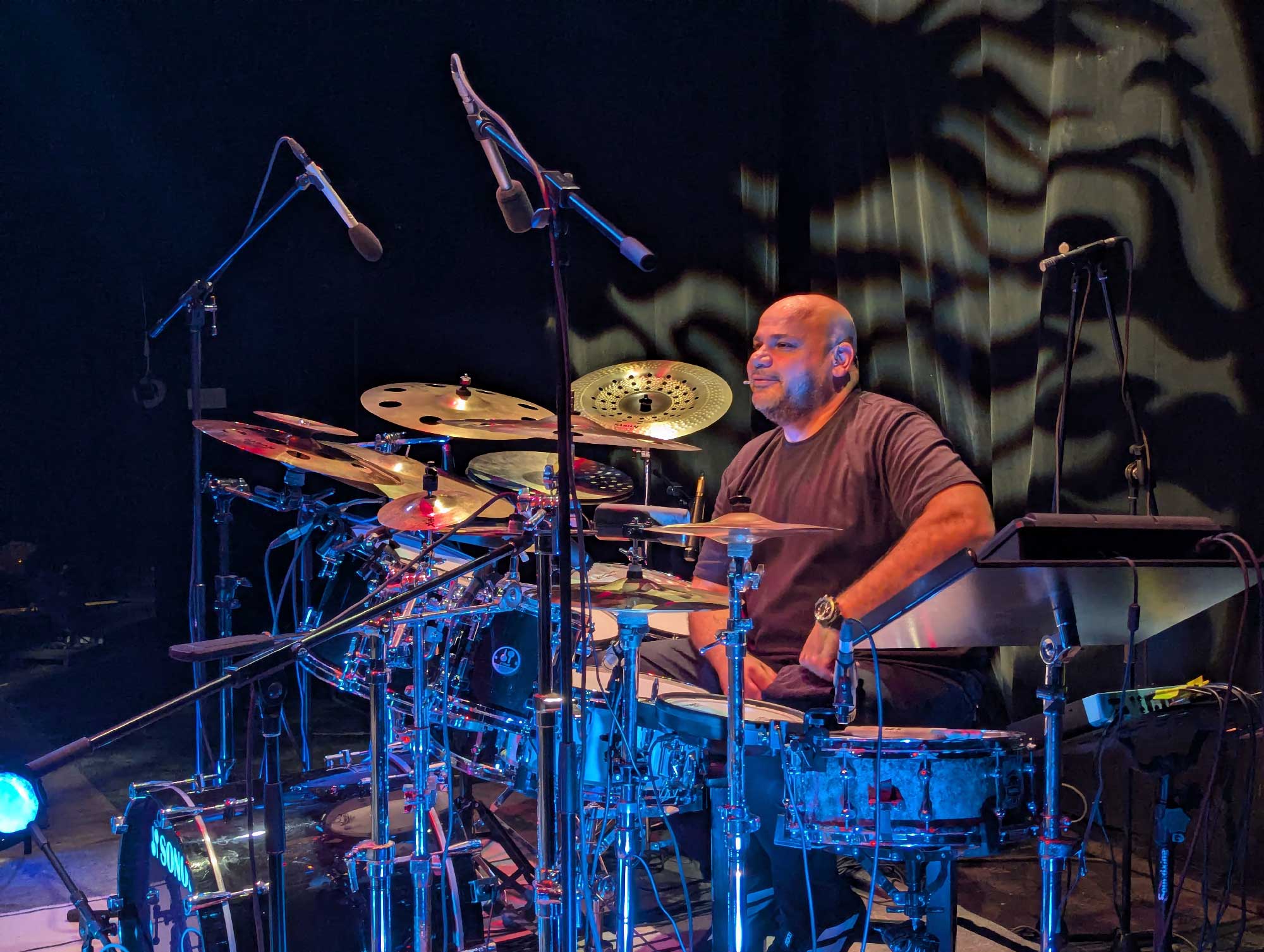 A drummer on stage with a drum set