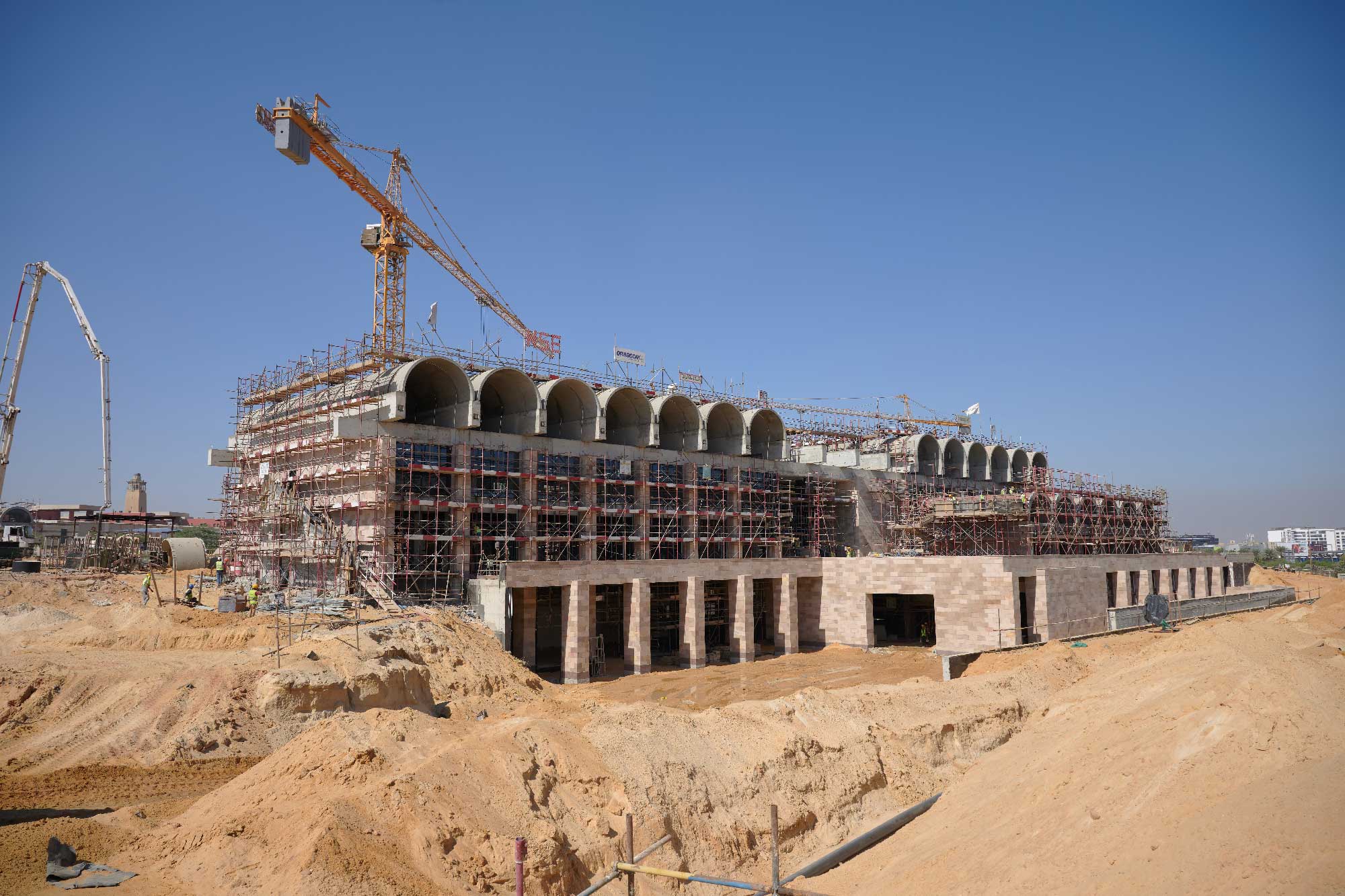 A building with arches on top under construction.