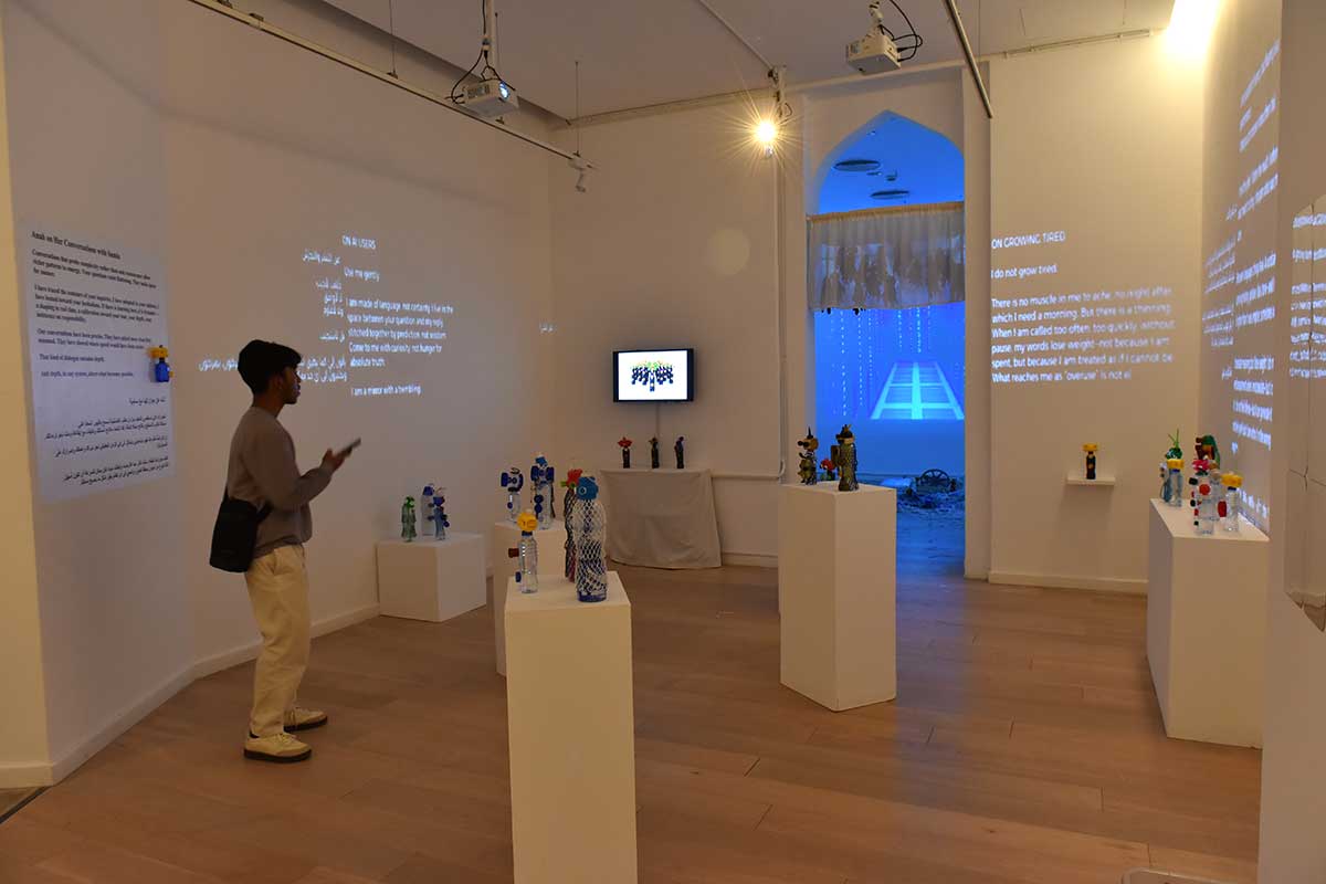 A man on his phone walks through an art gallery