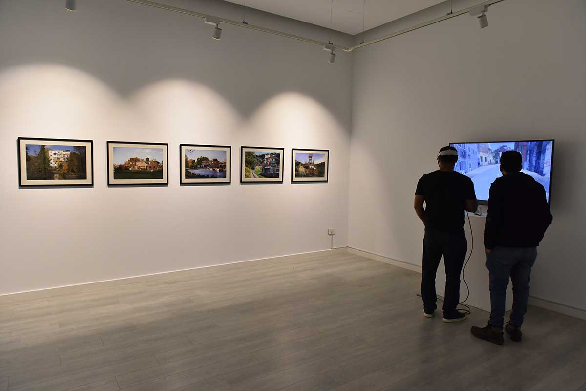 A person uses a virtual reality subset while another watches through a screen