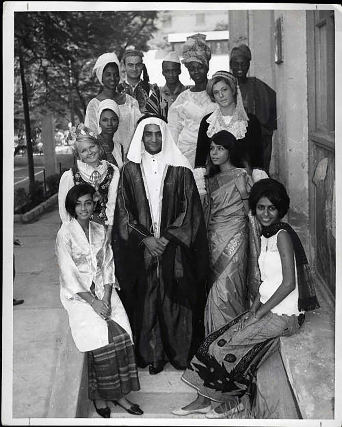 A group of students pose for a photo dressed in various cultural attire