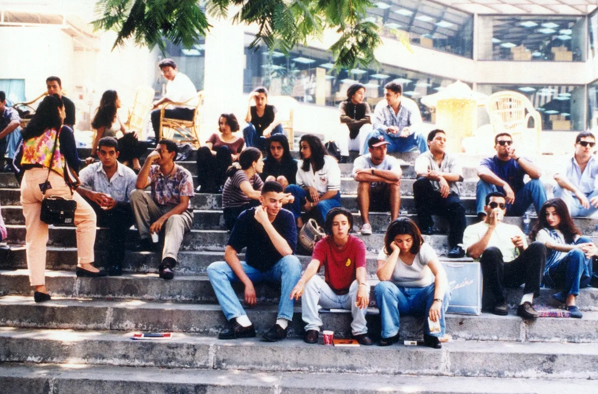students sit on the stairs at AUC's Greek campus