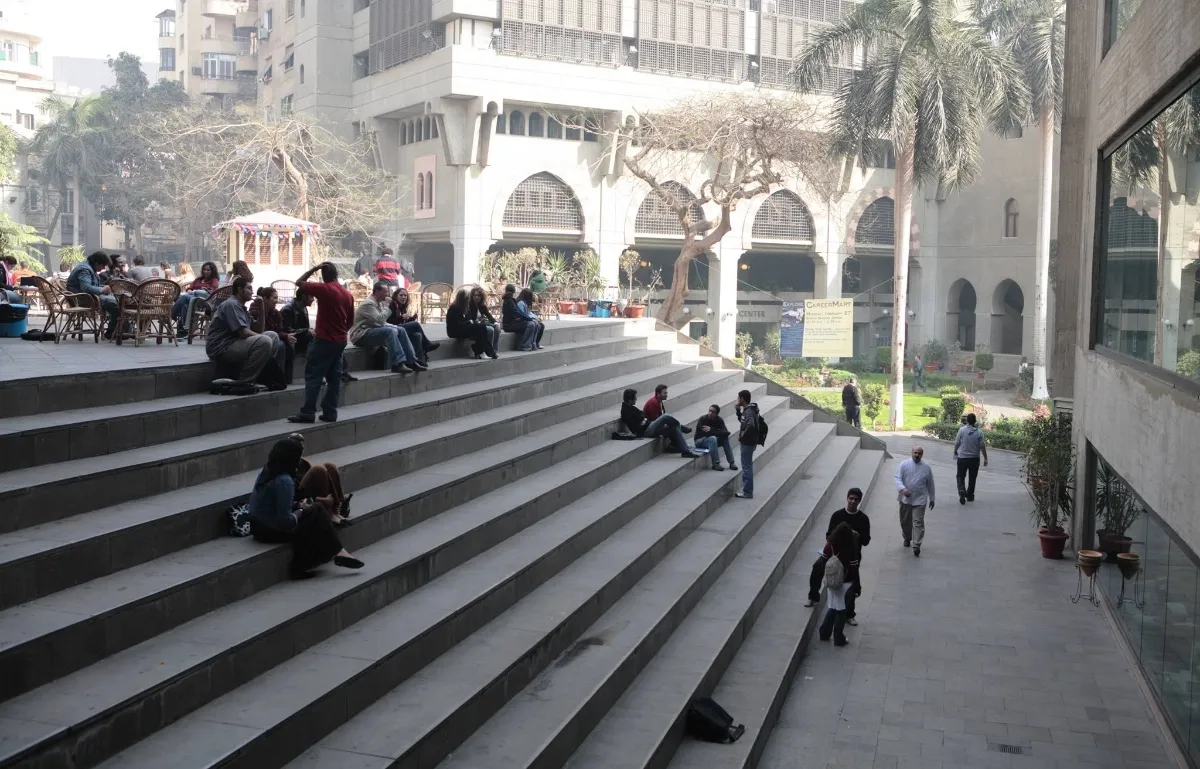 large set of stairs with students sitting on them in the middle of AUC's Greek campus