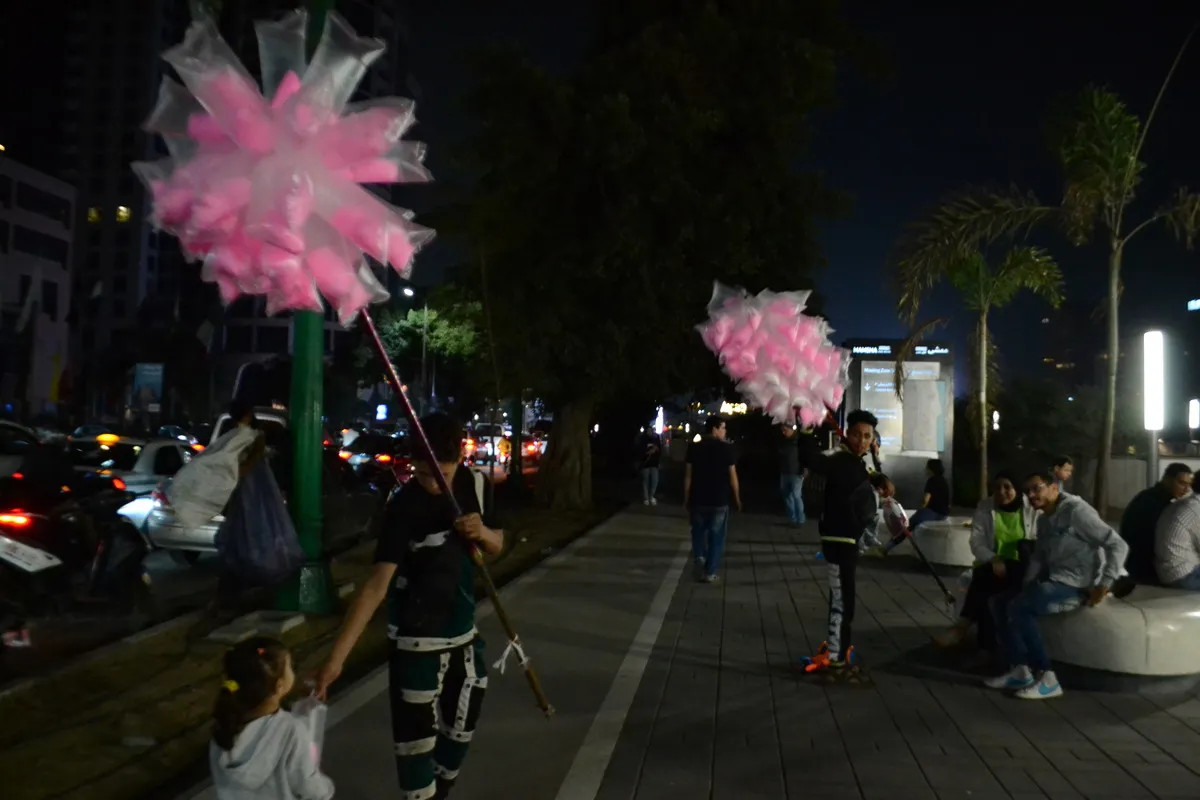 cotton candy vendors stand on the corniche at night
