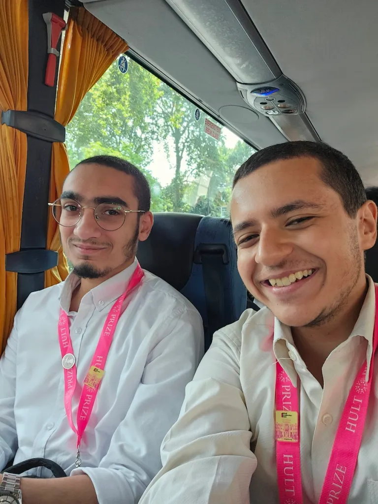 Two men take a selfie on a tour bus