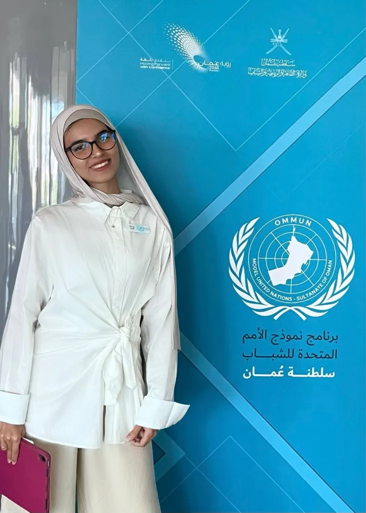 woman standing in front of a Model United Nations banner