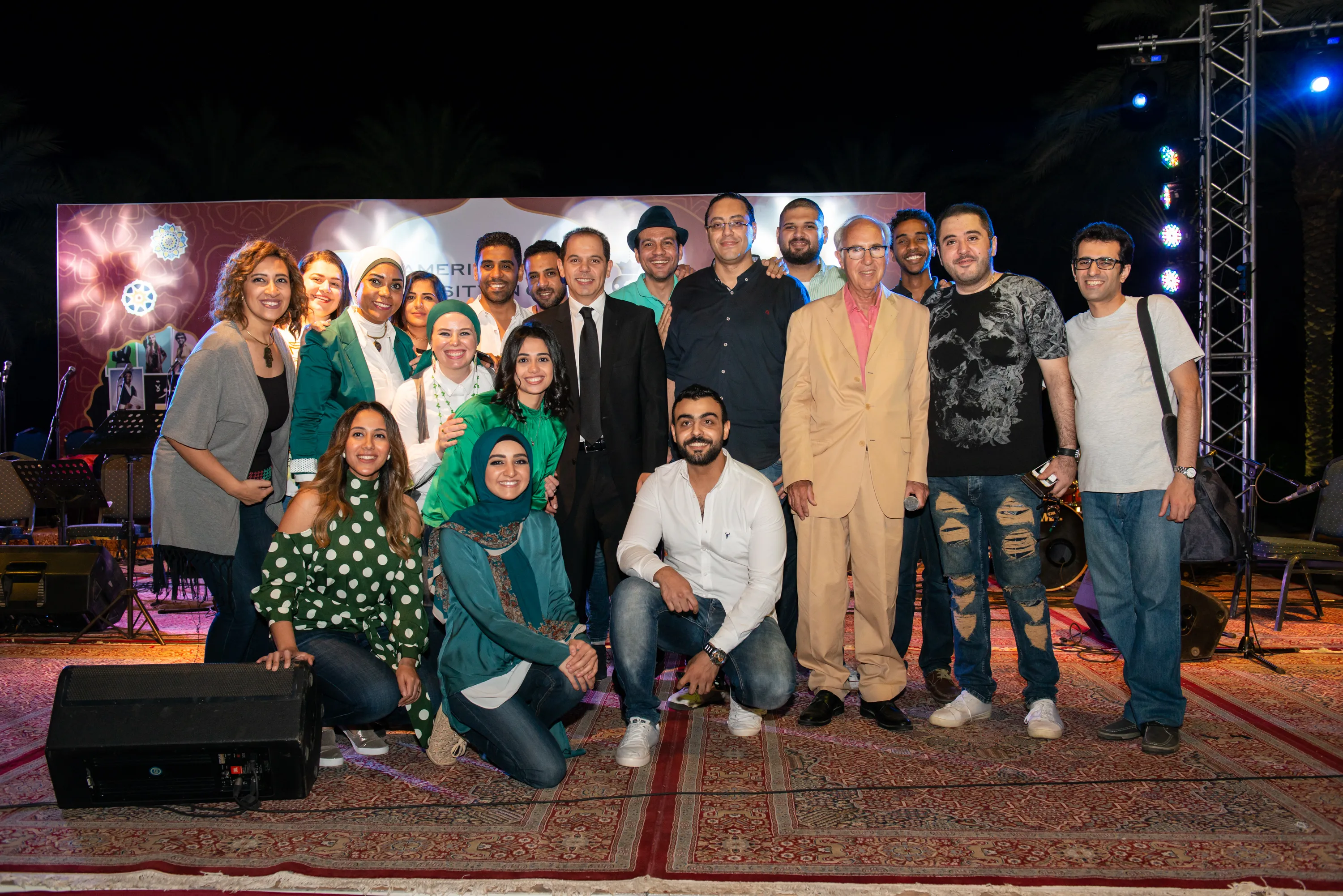 A group photo of performers on a stage 