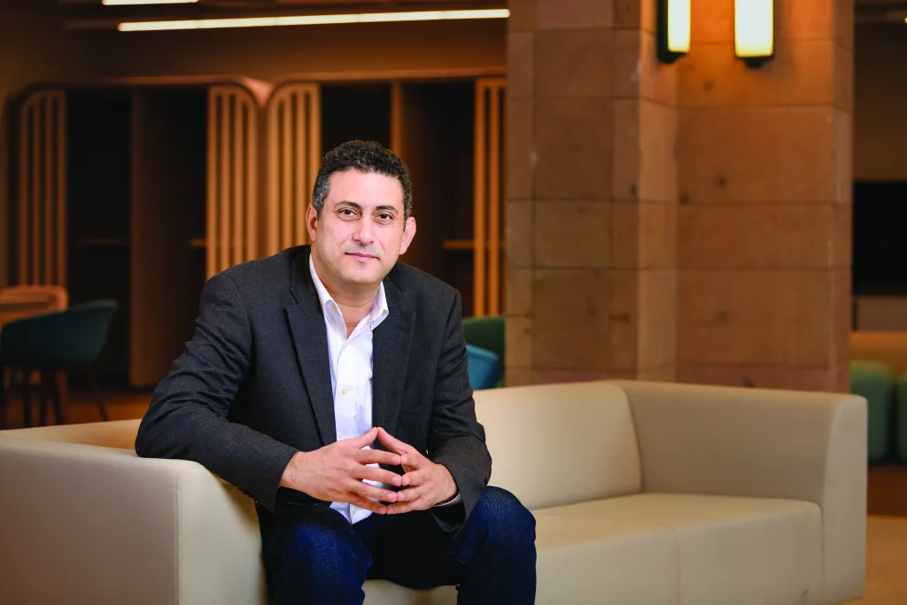 Man in a suit sits on a sofa at AUC's Innovation Hub
